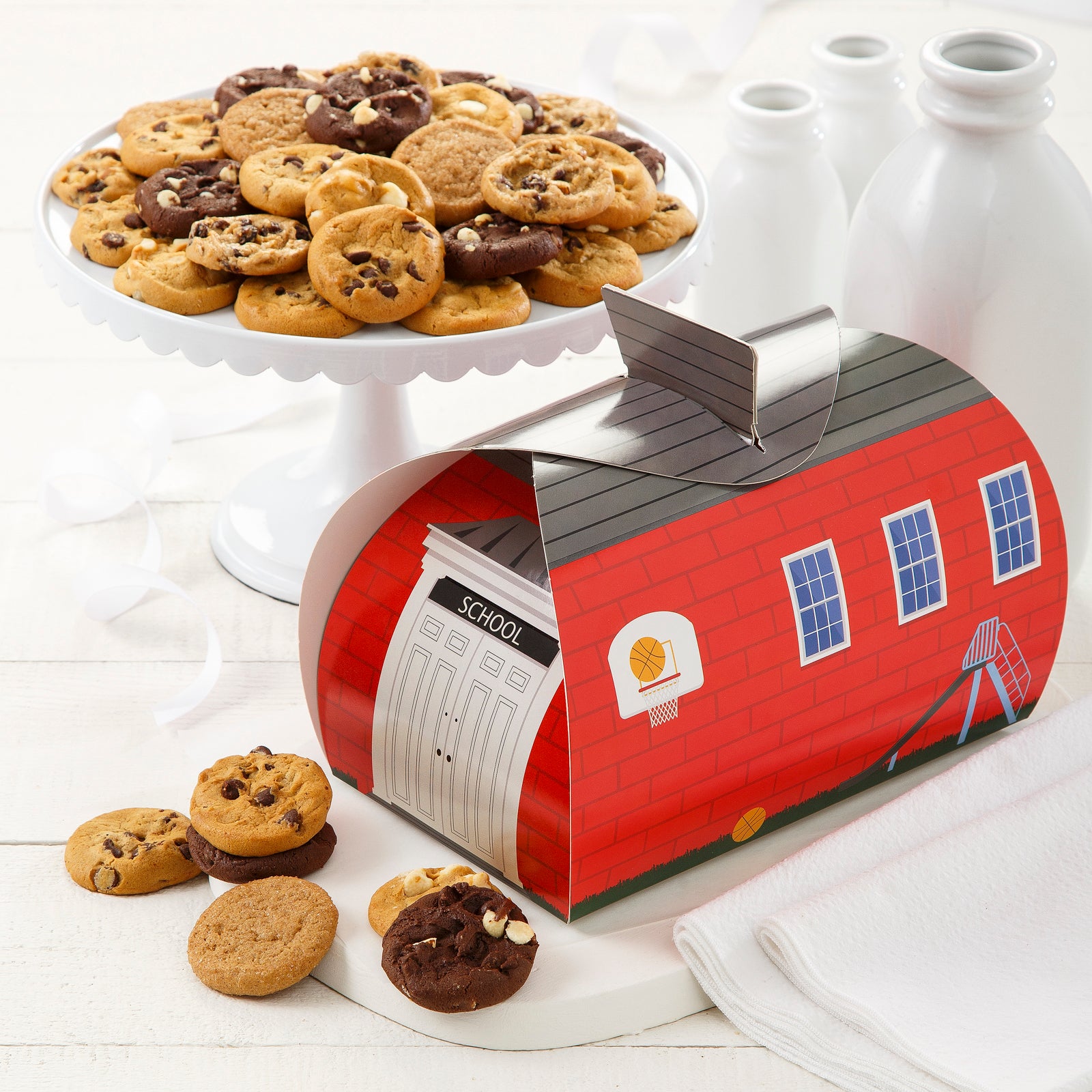 School house cookie carrier with a plate full of an assortment of Nibblers®
