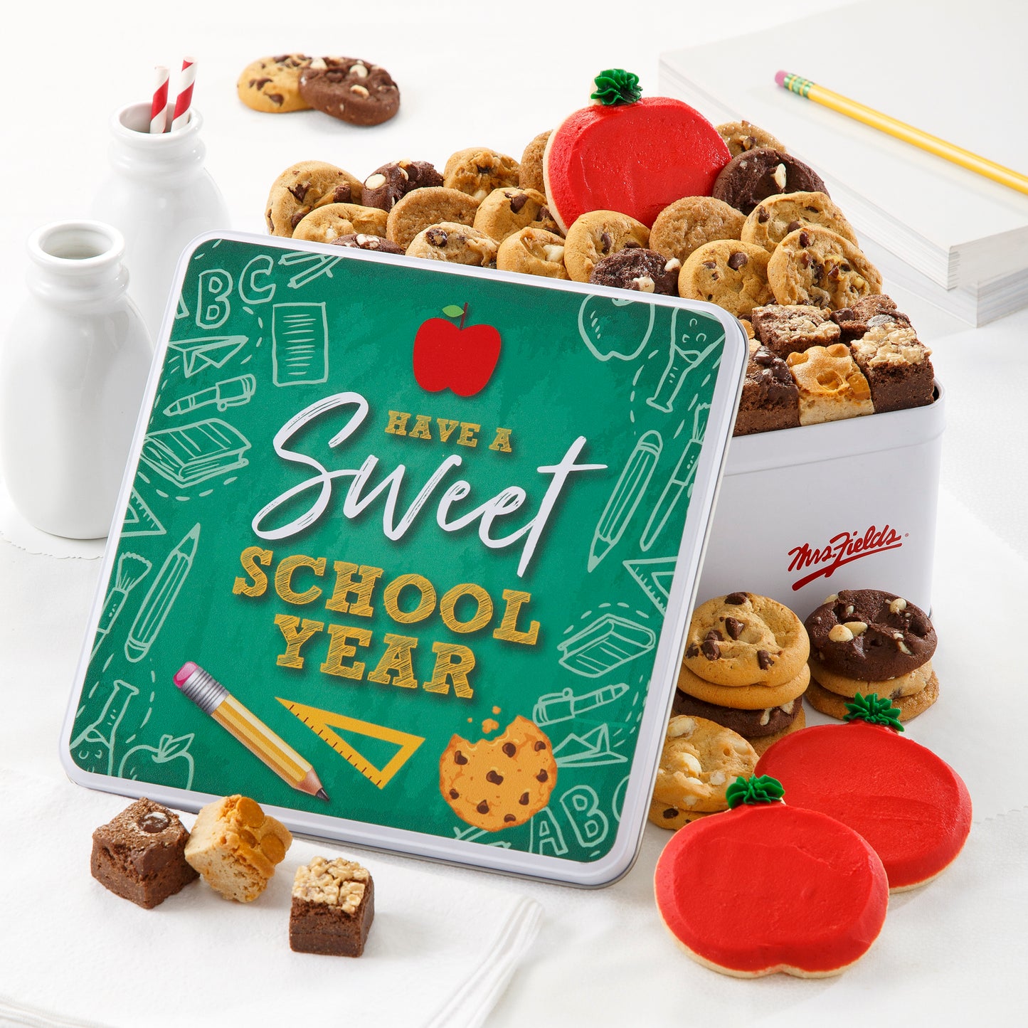 A school themed tin with the sentiment Have a Sweet School Year. This tin is filled with Nibblers®, brownie bites, and three frosted apple cookies
