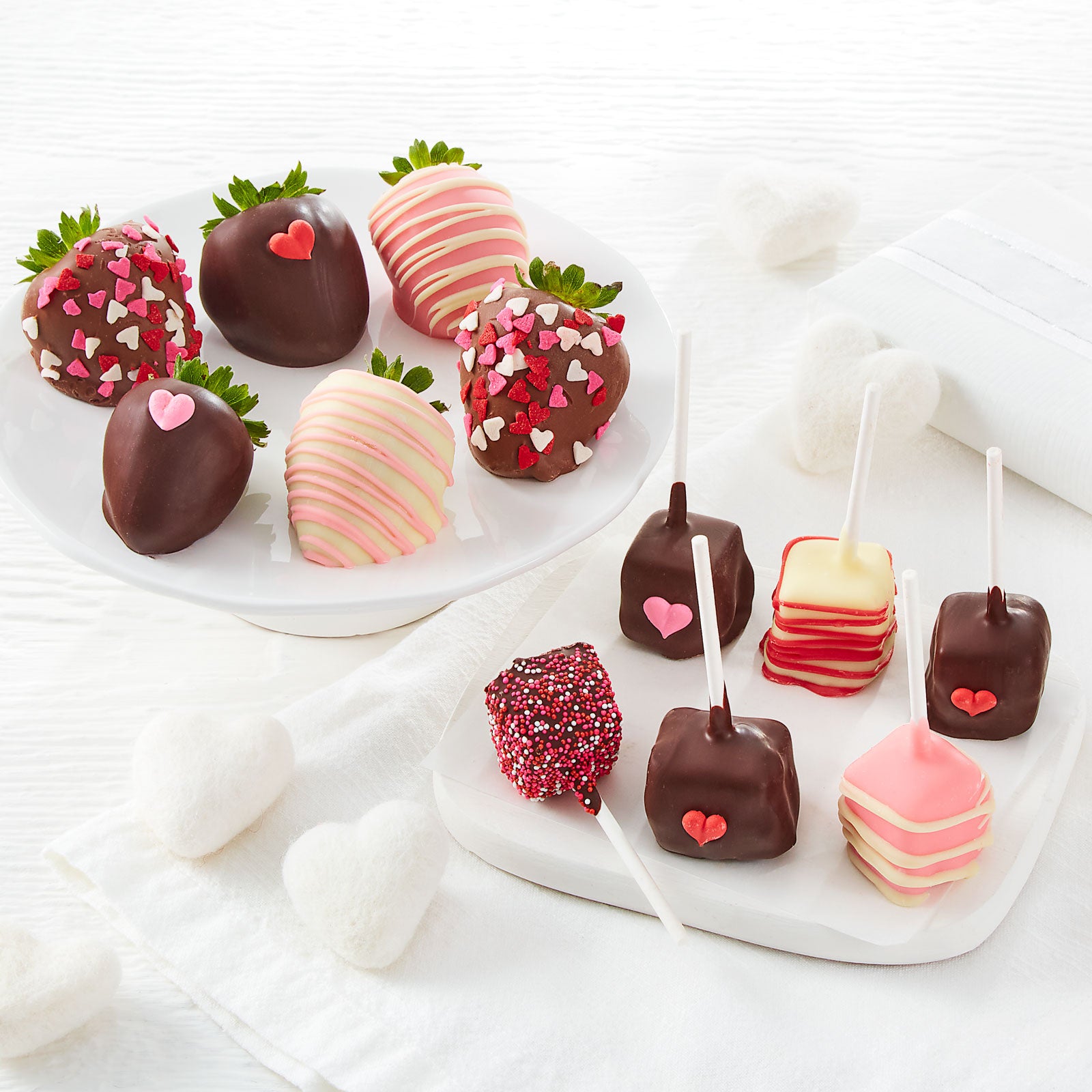 Valentine's Day themed chocolate covered strawberries and cheesecake pops