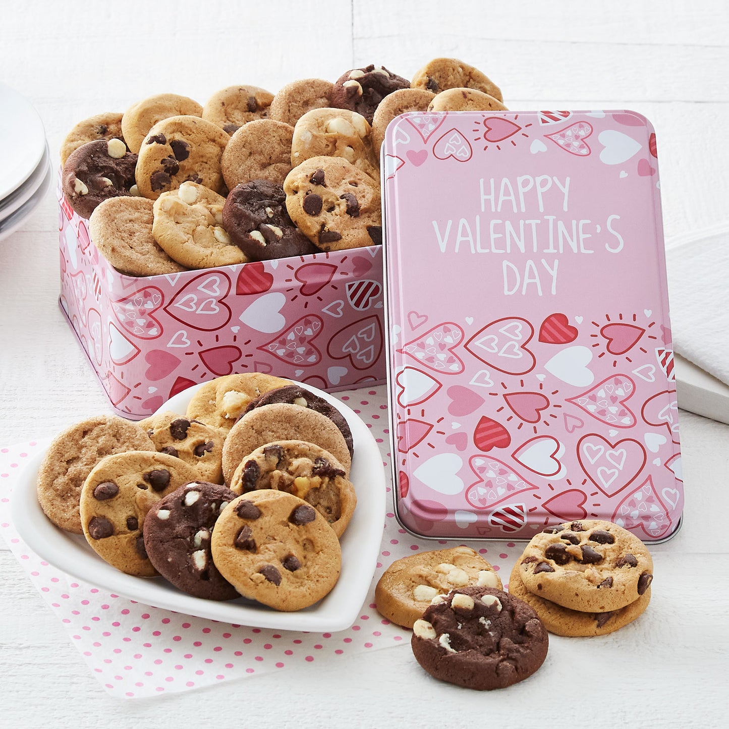 A pink with hearts Happy Valentine's Day gift tin filled with an assortment of Nibblers. 