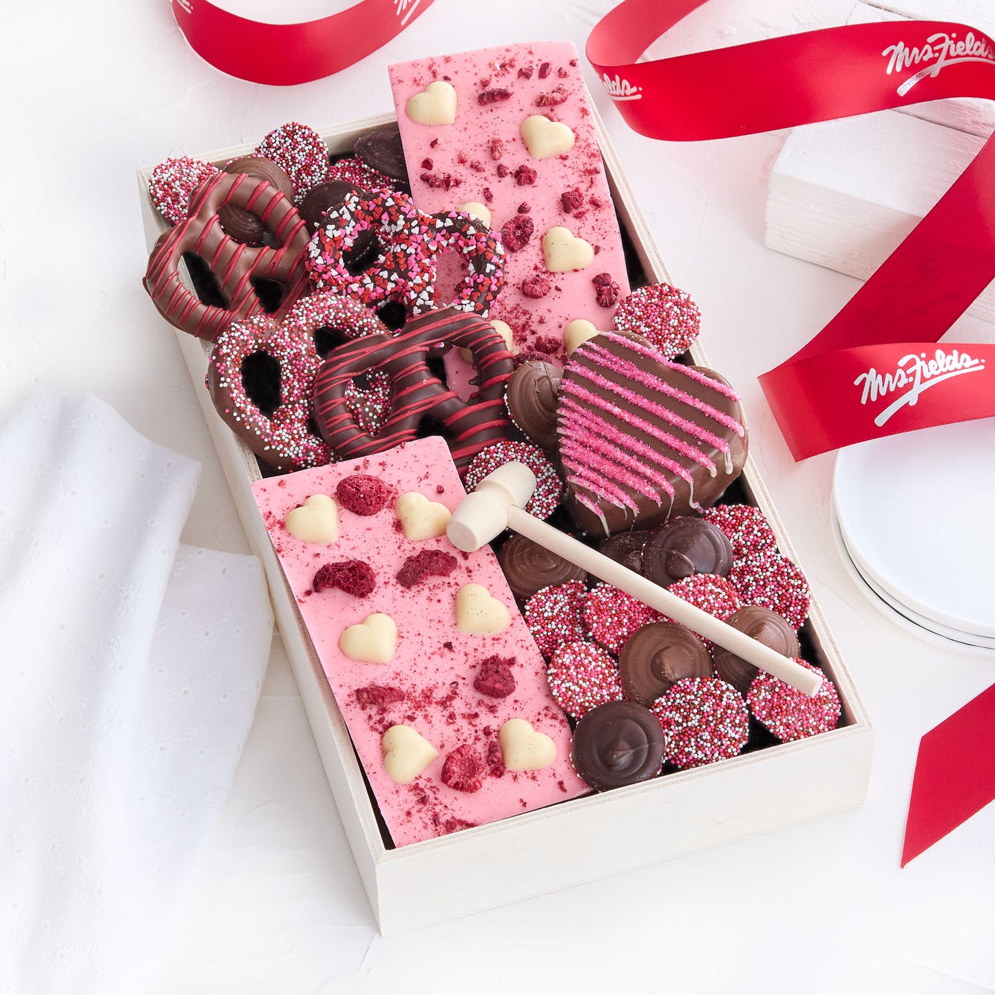 Valentine's Day themed chocolates and chocolate covered pretzels in a tray