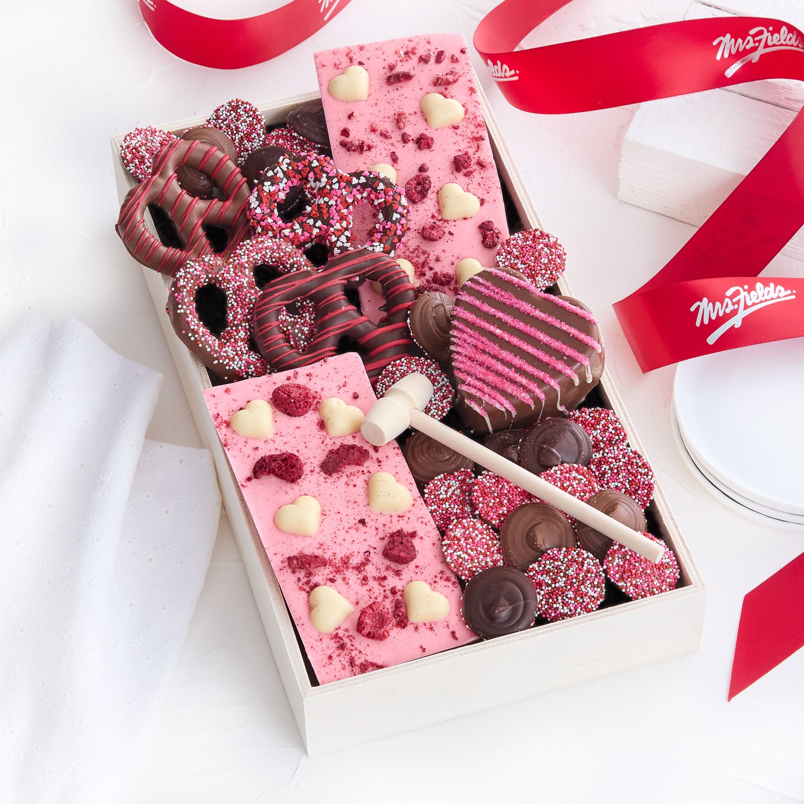 Valentine's Day themed chocolates and chocolate covered pretzels in a tray