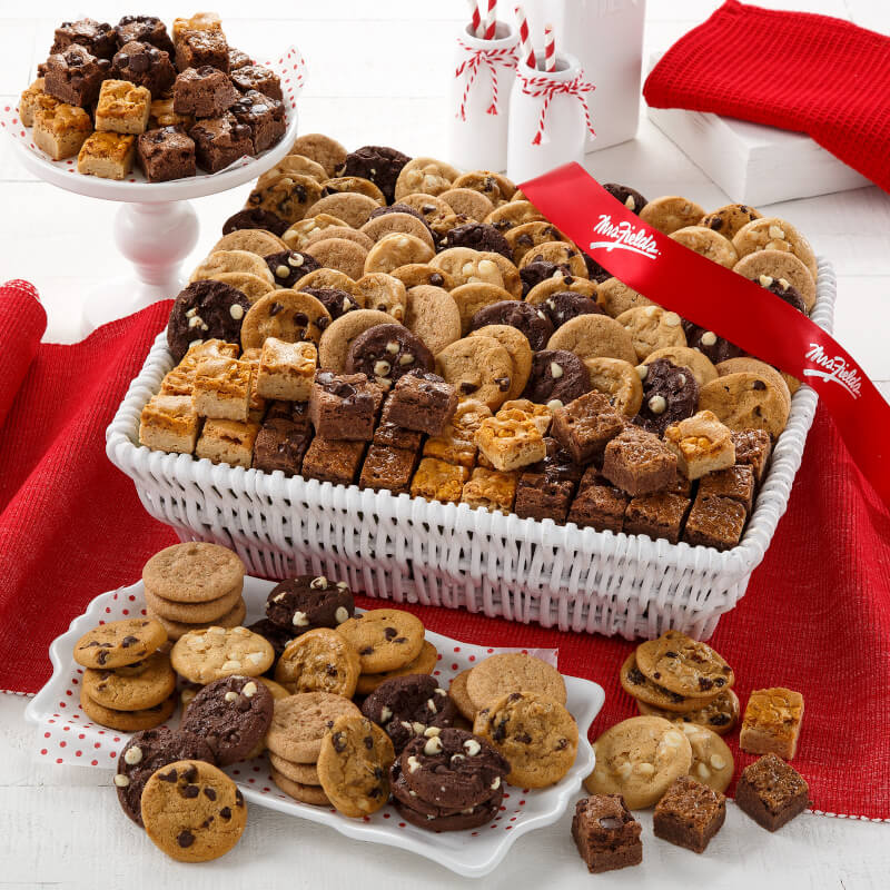 Abundant Combo Basket filled with an assortment of nibblers and brownie bites tied with a Mrs. Fields red ribbon