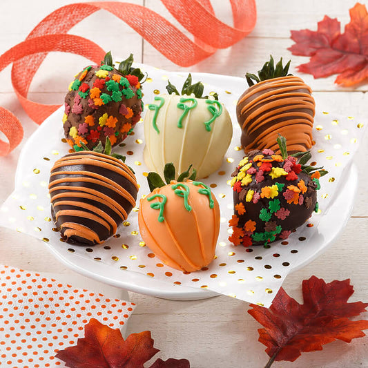 An assortment of Fall themed chocolate covered strawberries
