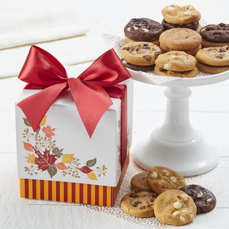 Fall themed mini box with an assortment of Nibblers® on a plate beside the gift box
