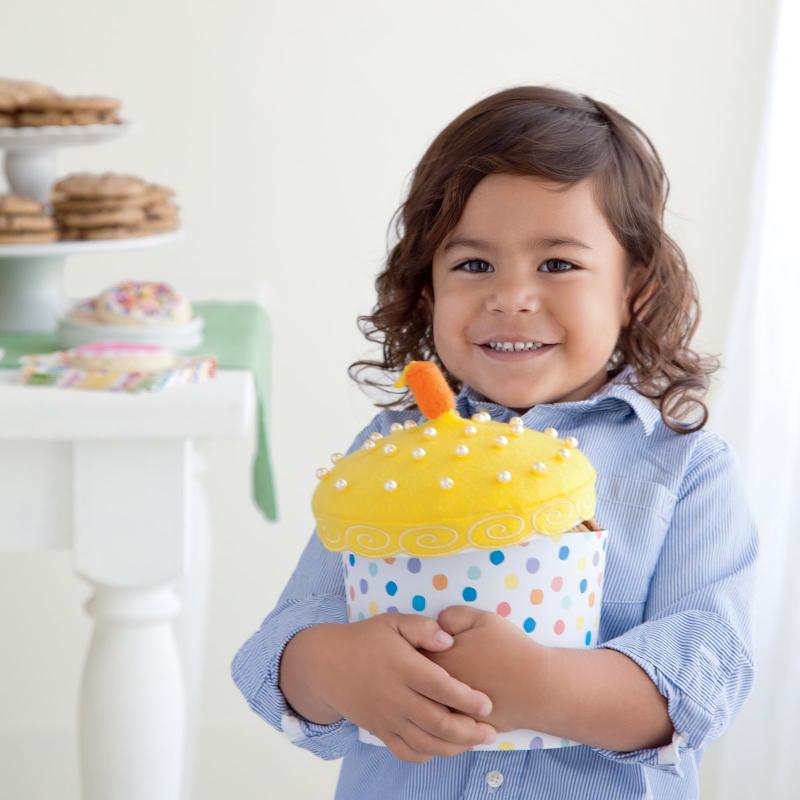 Little girl holding cupcake gift box
